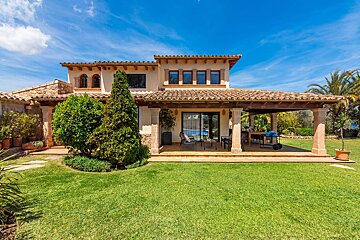 A large house with a large lawn in front of it