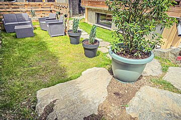 A garden with a lot of potted plants and rocks