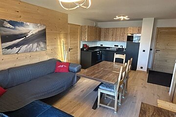A living room with a couch and a dining table