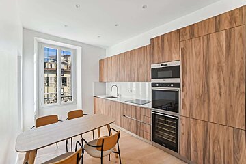 A kitchen with wooden cabinets and a wine cooler
