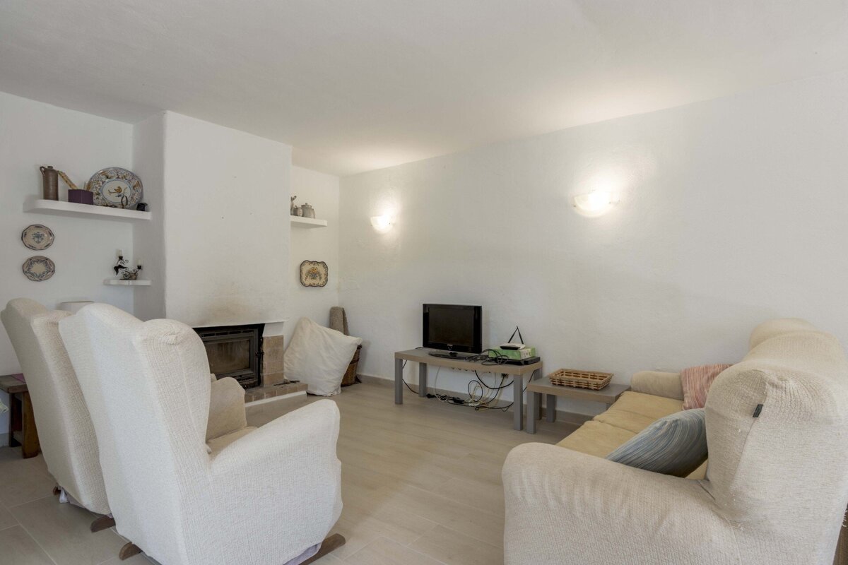 A living room with two chairs and a flat screen tv