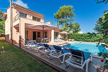 A large house with a swimming pool in front of it