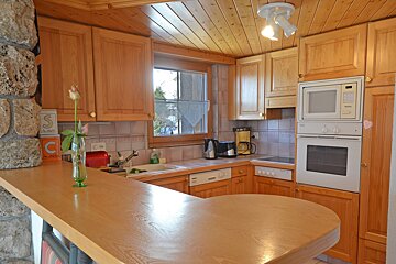 A kitchen with wooden cabinets and a microwave that says siemens on it