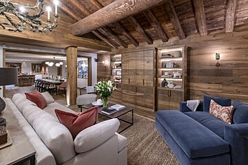 A living room with a blue couch and a white couch