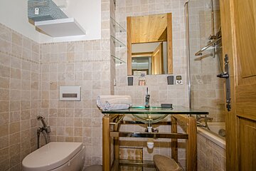 A bathroom with a toilet a sink and a mirror