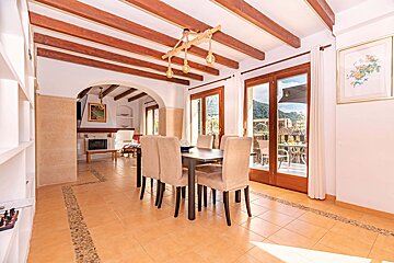 A dining room with a table and chairs and a fireplace