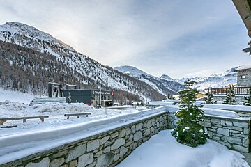 A snowy landscape with a telephone house in the foreground