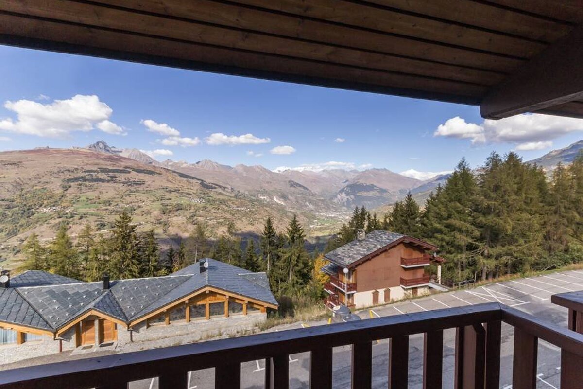 A balcony with a view of a mountain range