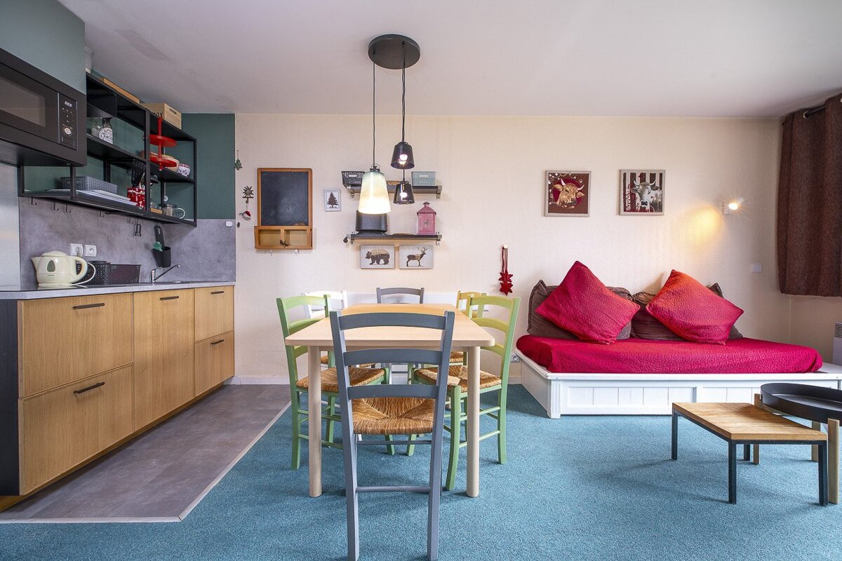 A living room with a couch and a table and chairs