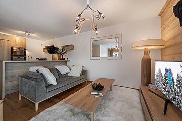 A living room with a couch and a flat screen tv