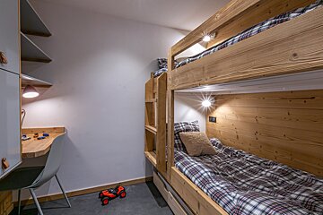 A bedroom with bunk beds and a large bed