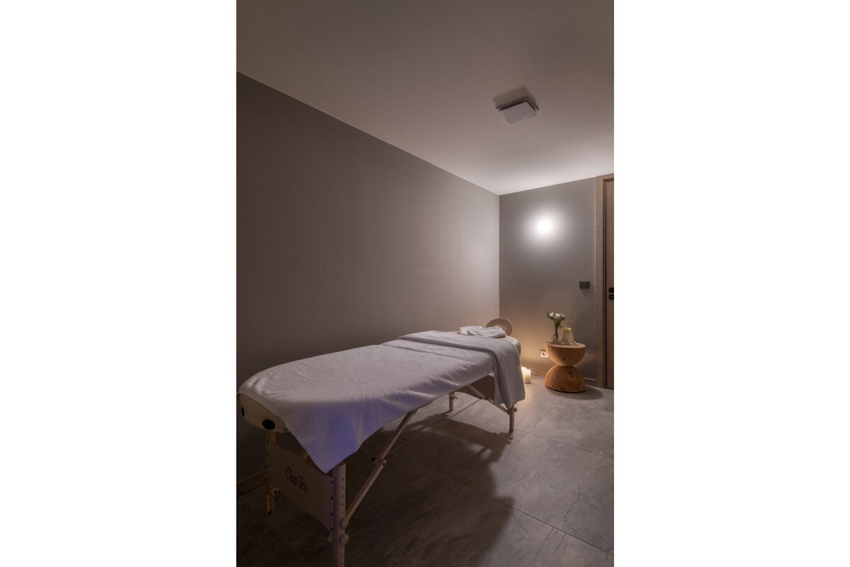 A massage table with a white towel on it