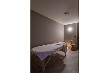 A massage table with a white towel on it
