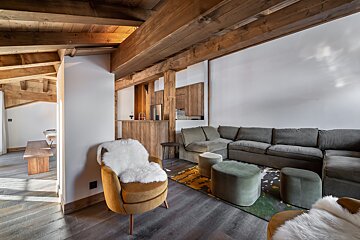 A kitchen and dining area with a wooden ceiling