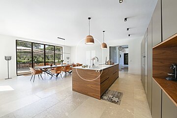 A kitchen with a large island in the middle