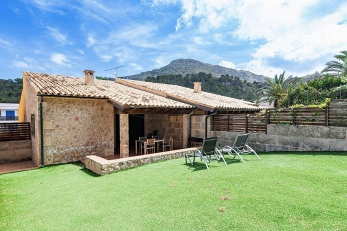 The backyard of a house with a mountain in the background