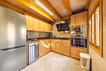 A kitchen with stainless steel appliances and wooden cabinets