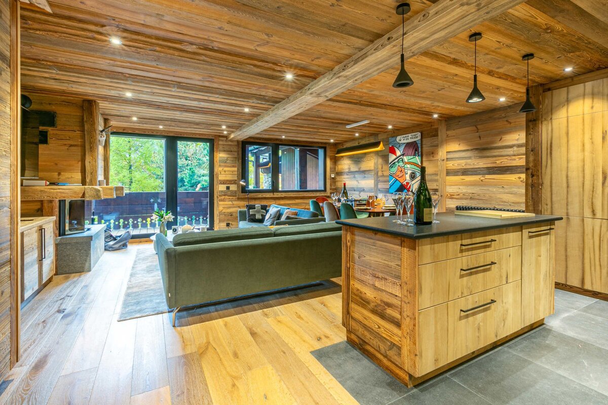 A bottle of champagne sits on a counter in a living room