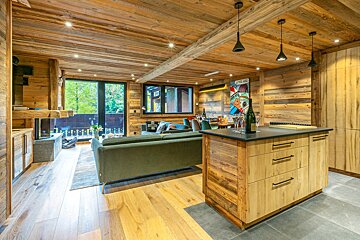 A bottle of champagne sits on a counter in a living room