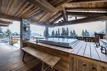 A wooden deck with a hot tub on it