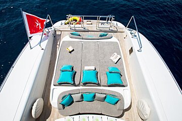 A boat with a flag on the side that says ' yacht ' on it