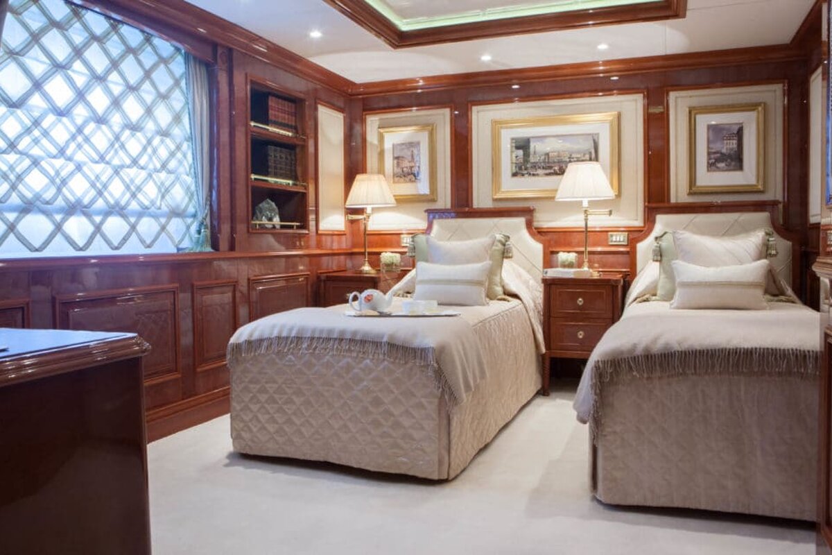A bedroom with two twin beds and a tray on the bed