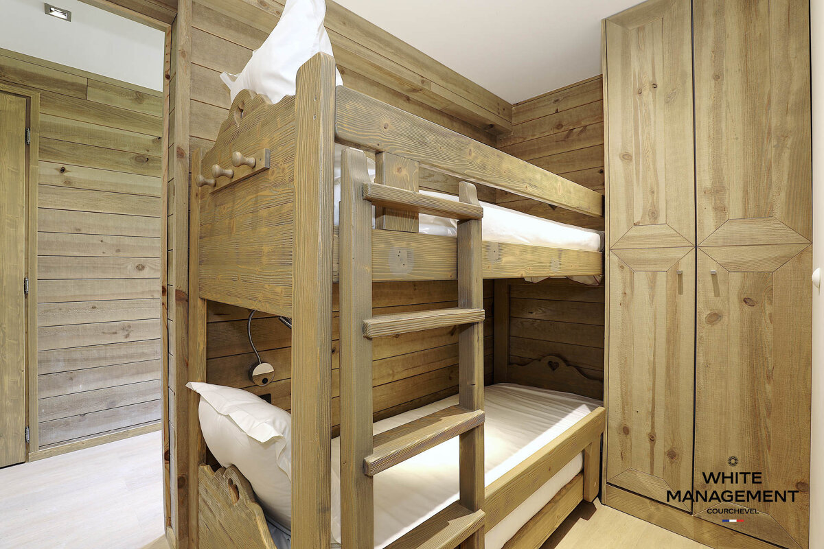 A hotel room with a bed and a mirror
