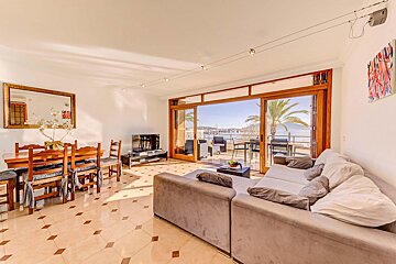 A living room with a couch and a table and chairs