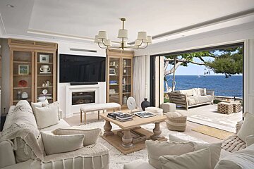 A living room with a large flat screen tv on the wall