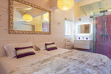 A bathtub in a bathroom with a large window