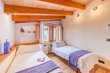 A bedroom with two beds and a book on the bed