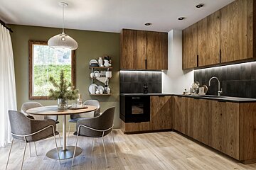 A kitchen with wooden cabinets and a round table