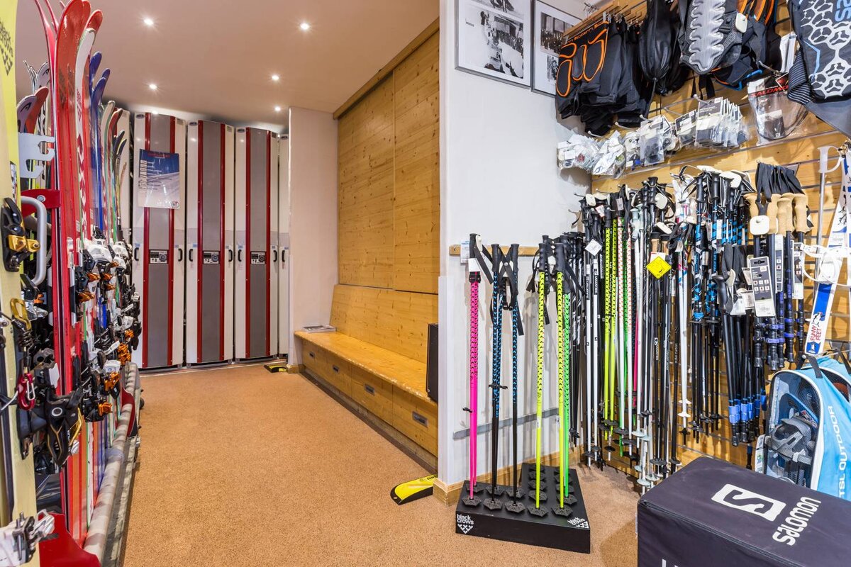 A salomon box sits next to a row of ski poles
