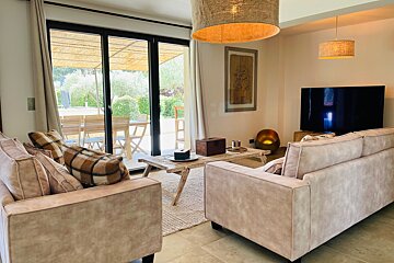 A living room with two couches and a flat screen tv