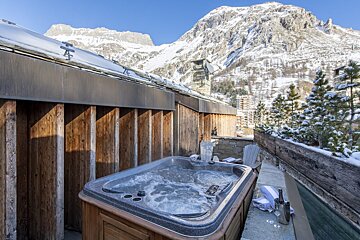A hot tub with a mountain in the background