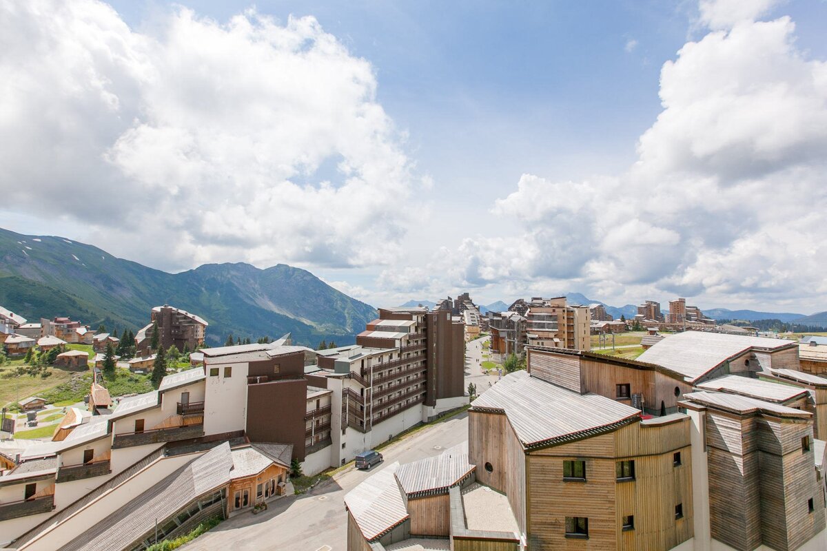 An aerial view of a ski resort with mountains in the background