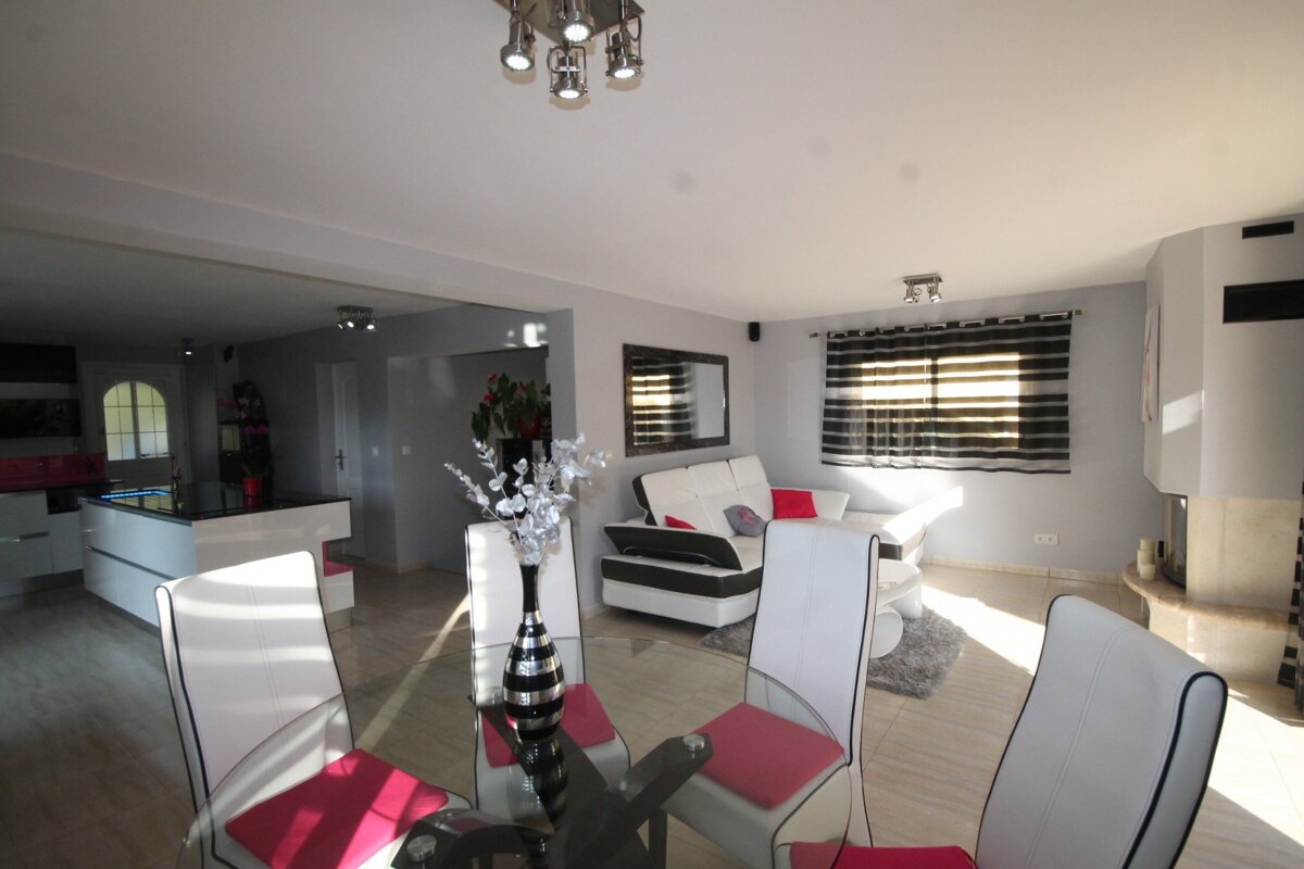 A living room with a dining table and chairs
