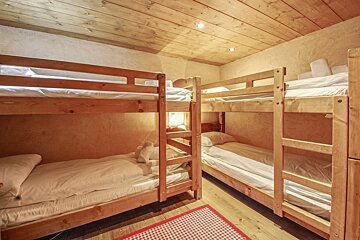 A room with bunk beds and a checkered rug