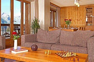 A living room with a couch and a chess board