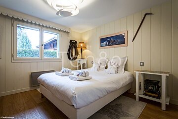 A bedroom with a picture of a horse on the wall