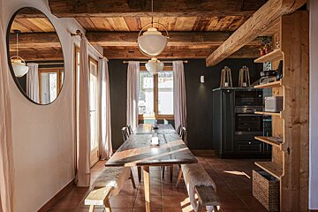 A dining room with a wooden table and benches