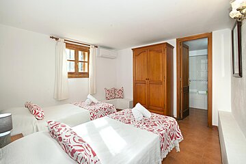 A bedroom with two twin beds and a wardrobe