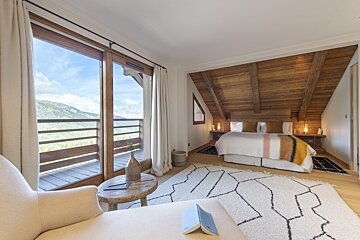 A bedroom with a bed and a book on the floor