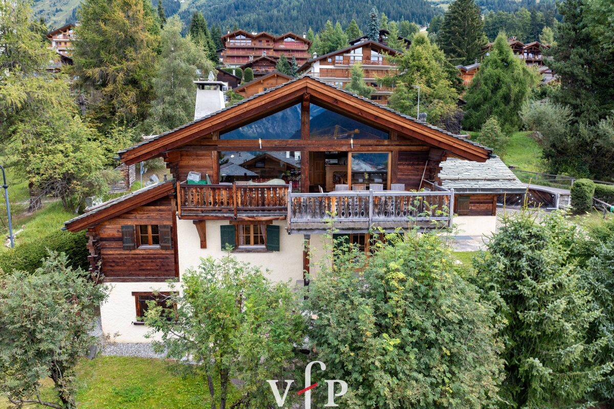 An aerial view of a chalet with the vip logo in the foreground