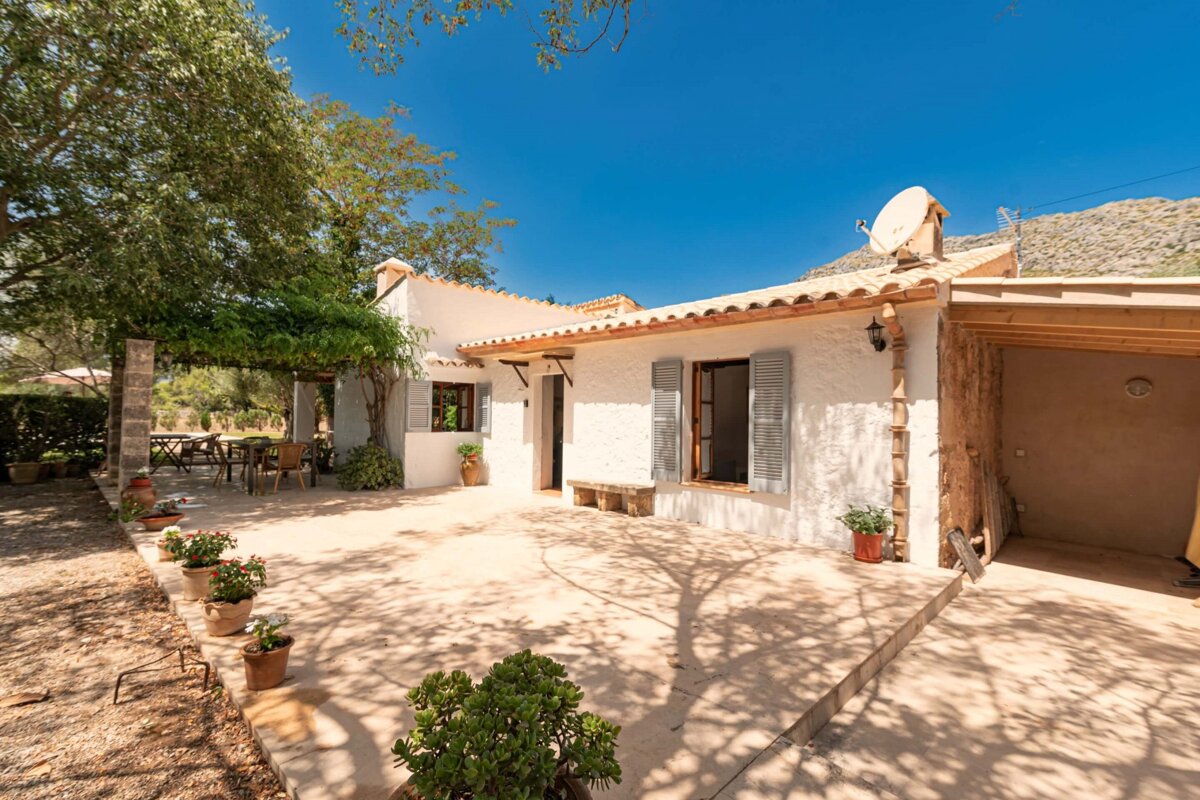 A white house with a satellite dish on the roof