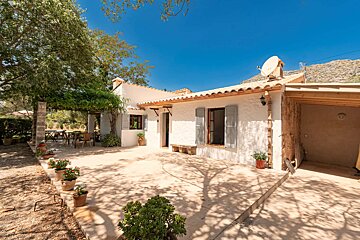 A white house with a satellite dish on the roof