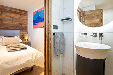 A bathroom with a sink and a painting on the wall