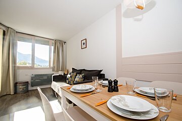 A dining room table with plates and glasses on it
