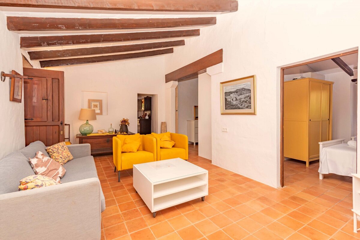 A living room with a couch and two yellow chairs