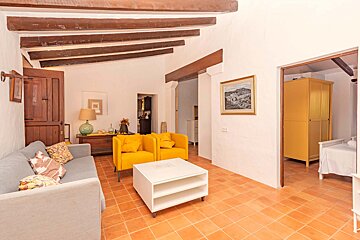 A living room with a couch and two yellow chairs